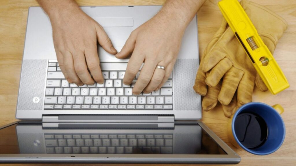 Tradie viewing business website on laptop